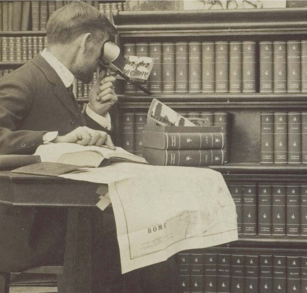 Man using stereograph viewer
