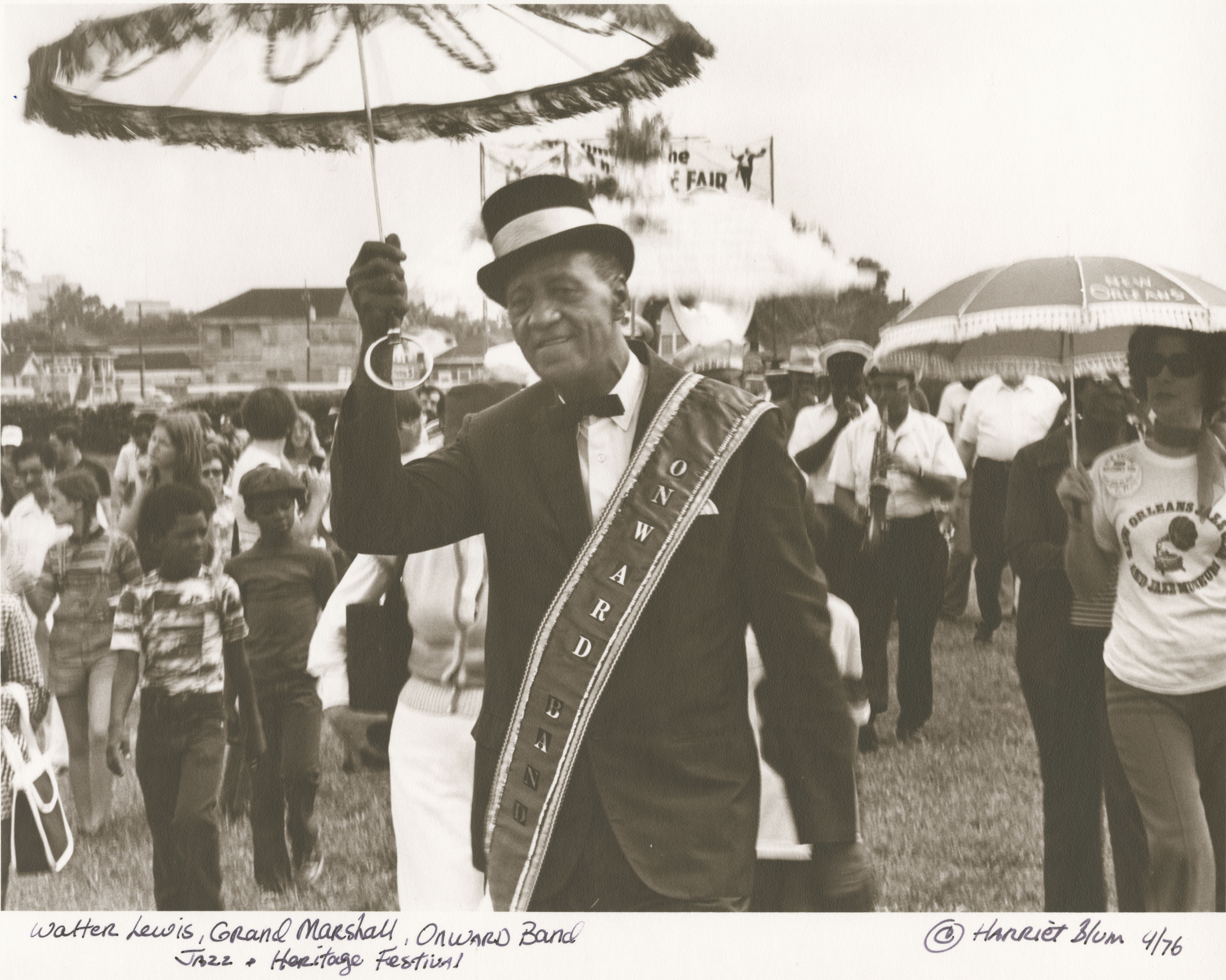 Photo: Grand Marshall Walter Lewis marches with the Onward Brass Band at Jazz Fest, 1976, photographer: Harriet Blum, Hogan Archive Photography Collection, PH003075, Tulane University Special Collections.