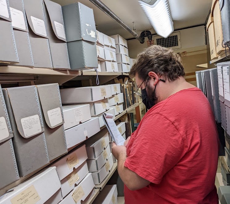 Matthew Folse conducting a collection survey in the TUSC stacks.