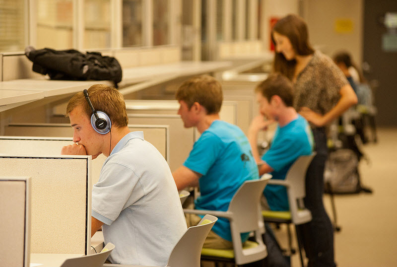 Students working quietly at individual carrels in the Selly Study Commons