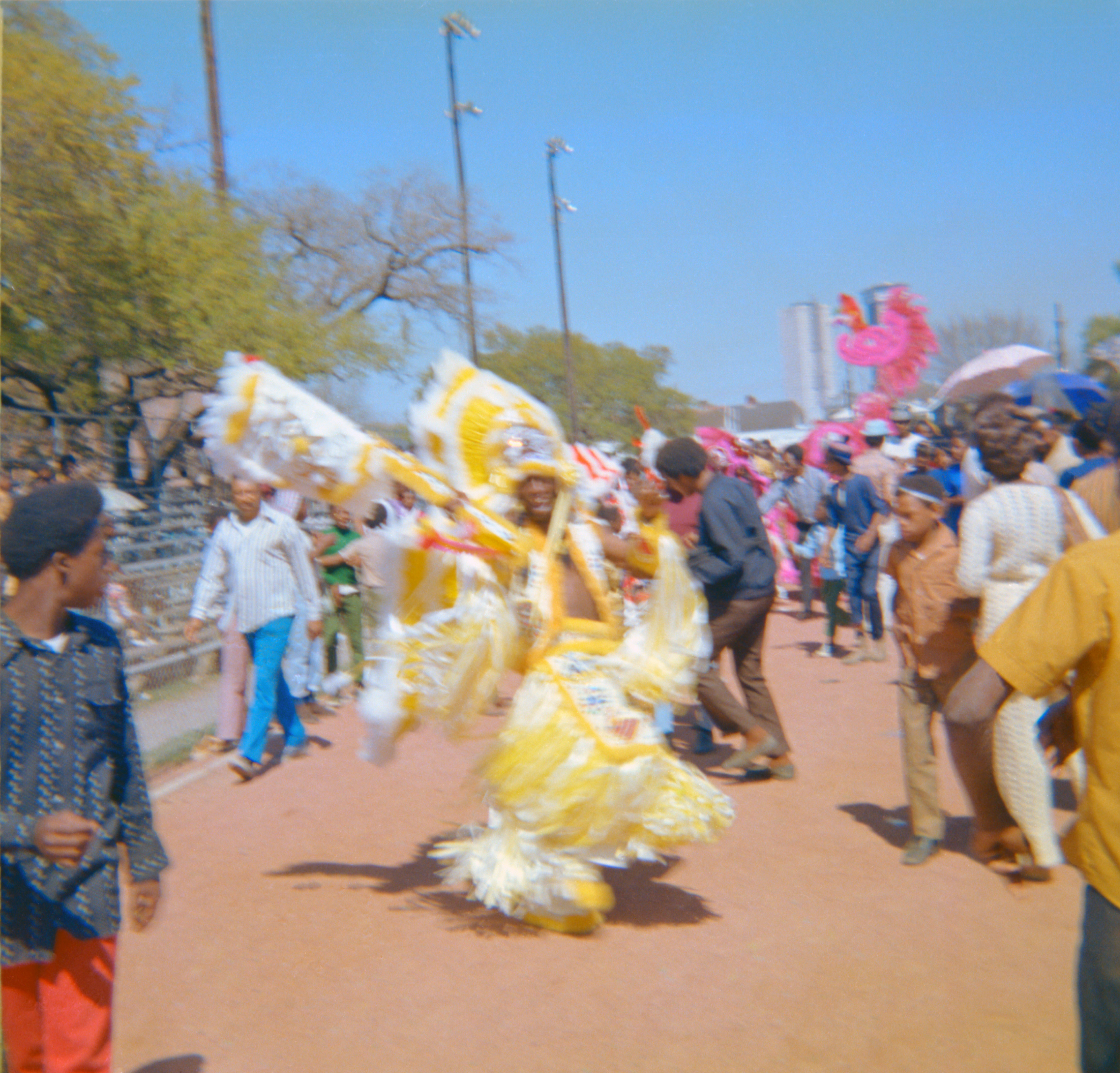 Photograph of an unidentified Mardi Gras Indian with community members, circa early 1970s, New Orleans, David Elliott Draper collection on Mardi Gras Indians, HJA-113, Tulane University Special Collections.