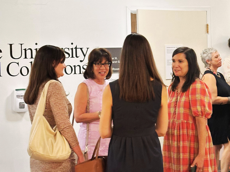 Vistors looking at the Cut from a Different Cloth Exhibit