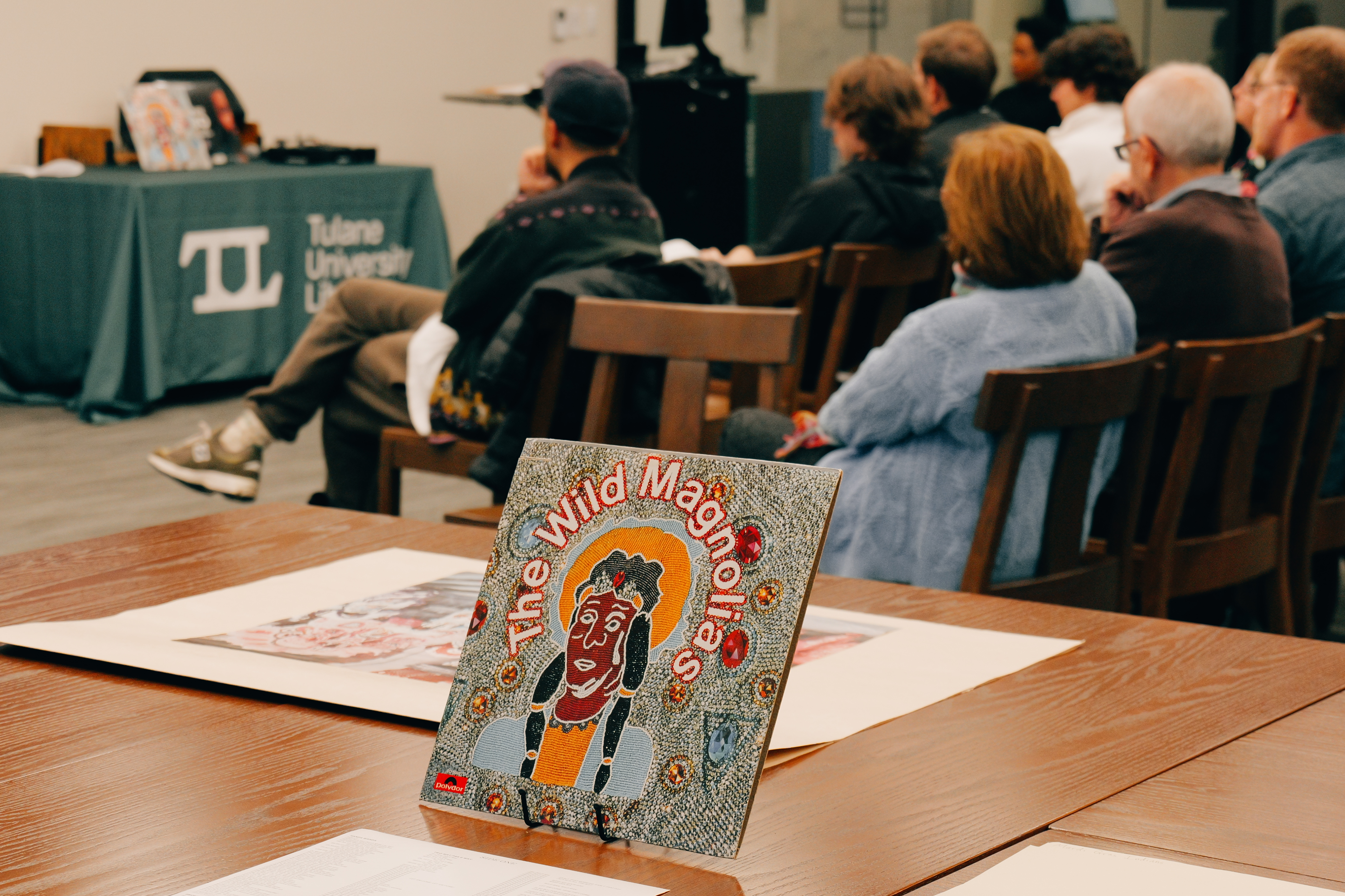 Attendees and archival materials at Intentional Listening: Mardi Gras Indians event on 02/17/2025. Photo by Alan Velasquez.