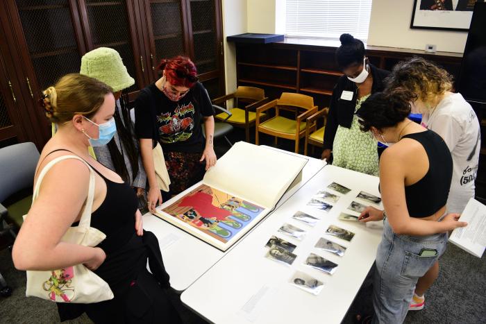"students viewing prints and photographs"