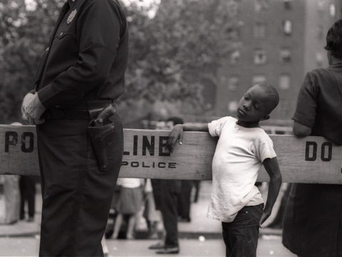 boy standing by police line