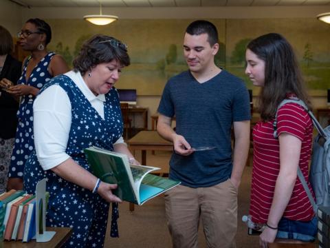 Ann Case, university archivist, speaks with students in the TUSC Reading Room