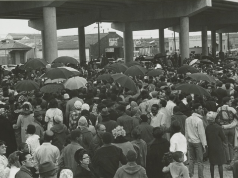 Crowd accompanying funeral procession; North Claiborne Avenue